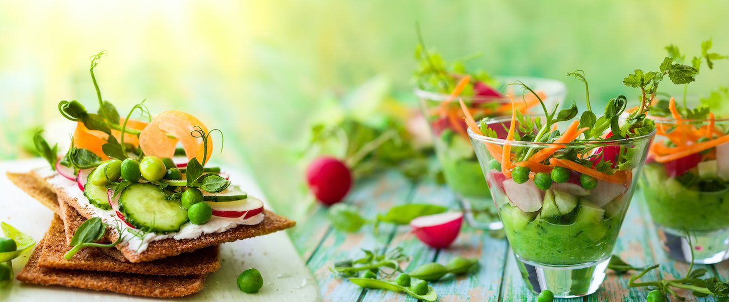 Variety of healthy appetizer: toasts and salads with fresh vegetables