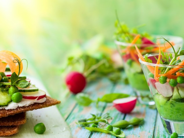 Variety of healthy appetizer: toasts and salads with fresh vegetables