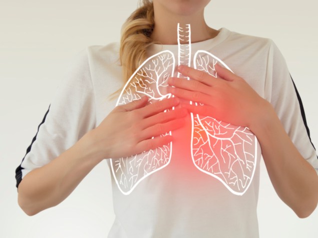 donna con maglietta bainca che lamenta dolore al petto