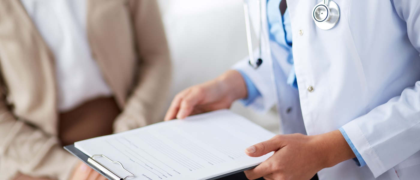 medico che mostra una cartella ad una paziente