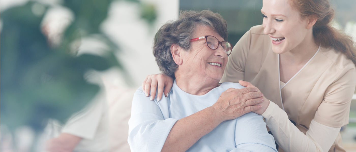 persona anziana assistita da un caregiver