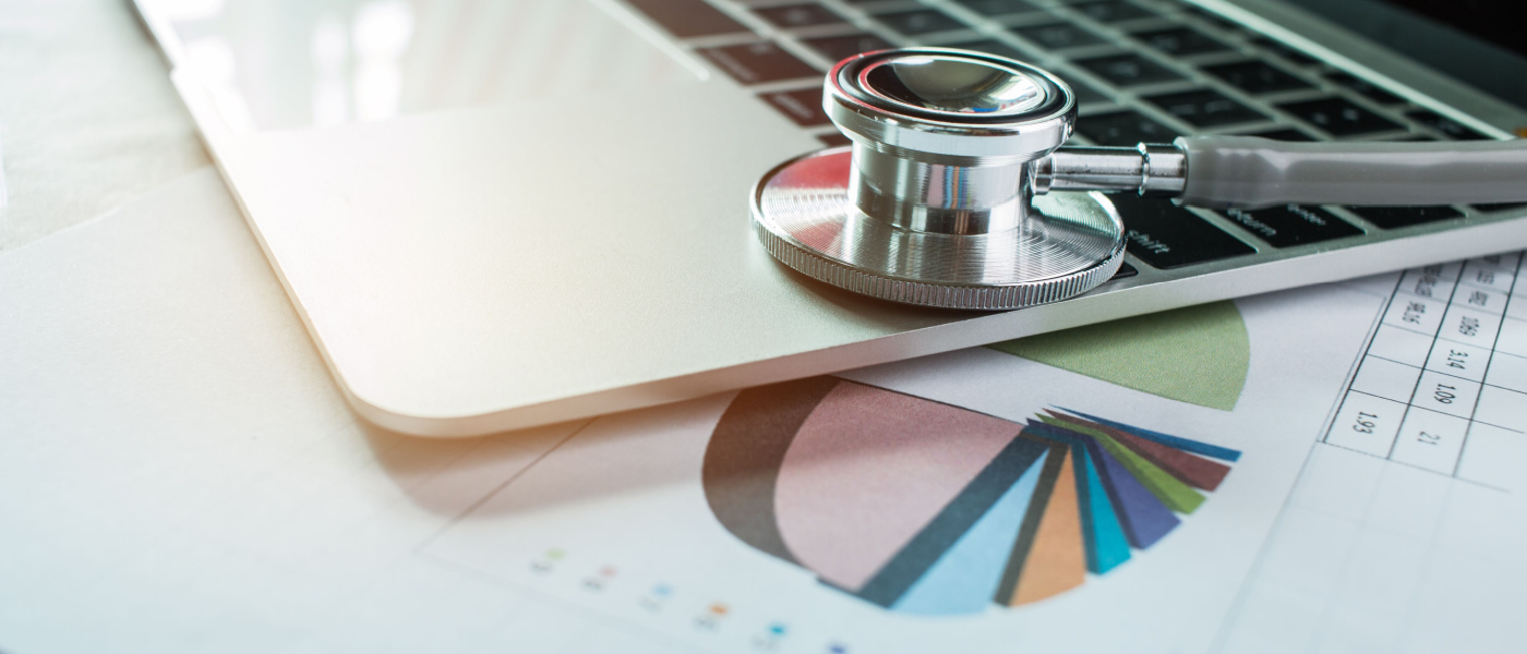 Stetoscopio su computer con i risultati dei test in Sfondo della stanza di consulenza medica e grafico dei rapporti per