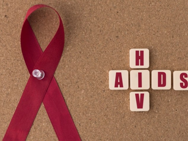 nastrro rosso e scritta "AIDS/HIV " su una bacheca di informazioni