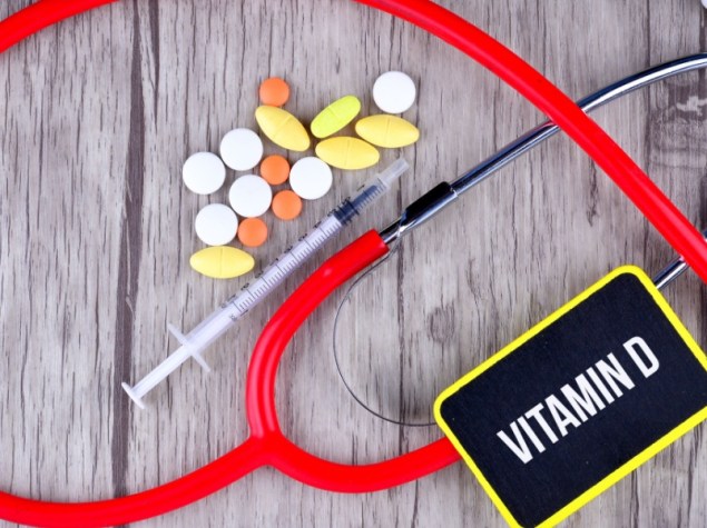 apparecchio medico con accanto siringa , pillole , e la scritta Vitamina D