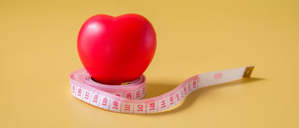 Palla rossa del cuore sul nastro di misura.